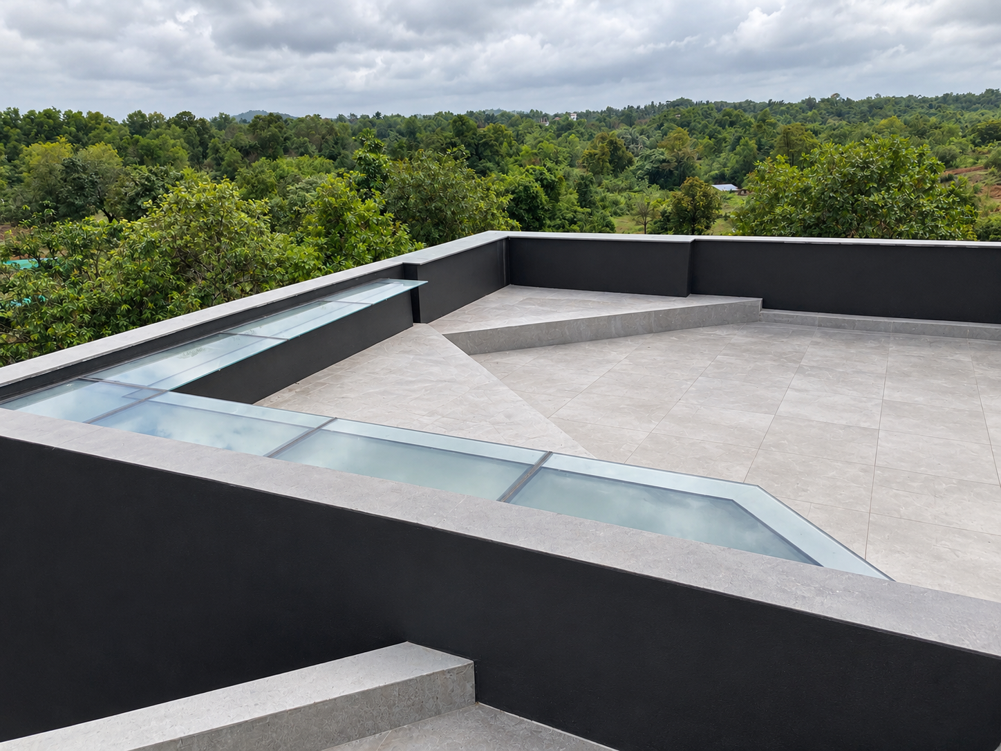 Roof terrace with glass skylight and scenic forest view