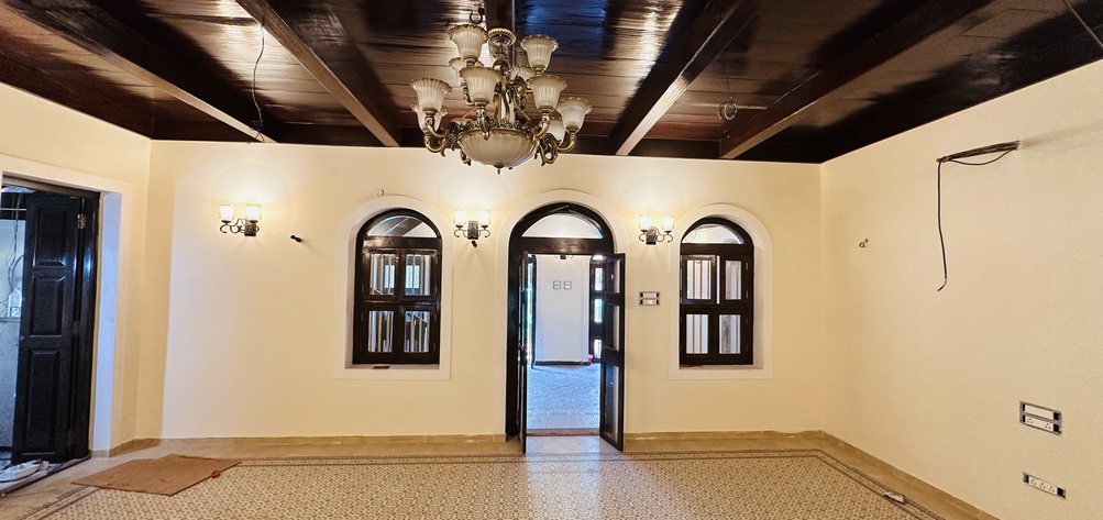 Restored Heritage Living Hall with Timber Ceiling and Chandelier