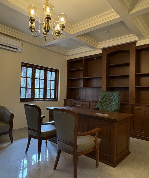 Classic teak study with coffered ceiling and antique chandelier